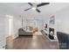 Spacious living room features modern ceiling fans, a fireplace, and a comfortable gray sectional at 3808 Severn Ave, Charlotte, NC 28210
