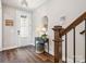 Welcoming foyer featuring hardwood floors, a decorative table, and stairs leading to the upper level at 403 Old Town Village Rd, Waxhaw, NC 28173