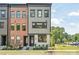 Charming townhome with a combination of brick and gray siding, complemented by lush landscaping at 403 Old Town Village Rd, Waxhaw, NC 28173
