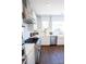 Well-lit kitchen boasts stainless steel appliances, white cabinets, subway tile backsplash, and hardwood floors at 403 Old Town Village Rd, Waxhaw, NC 28173
