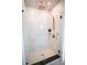 A modern shower with sleek hardware, white tile, and frameless glass doors at 403 Old Town Village Rd, Waxhaw, NC 28173