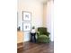 Cozy sitting area with a green armchair, side table, and stylish decor near a bright window at 403 Old Town Village Rd, Waxhaw, NC 28173