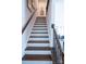 Staircase with wood treads and white risers, leading to the upper level of the home at 403 Old Town Village Rd, Waxhaw, NC 28173