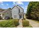 Well-maintained two-story home with neat landscaping, walkway, and gray exterior at 4627 Eaves Ln, Charlotte, NC 28215