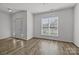 Living room with a front door, sidelights, a window, and wood floors at 4627 Eaves Ln, Charlotte, NC 28215