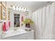 Classic bathroom featuring a vanity with ample lighting, decorative accents, and a shower with curtain at 5001 Sharon Rd # H, Charlotte, NC 28210