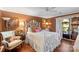 Charming bedroom with decorative white iron bed frame, wood floors, and ample natural light at 5001 Sharon Rd # H, Charlotte, NC 28210