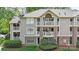 Condo building featuring multiple balconies, large windows, and professionally maintained landscaping at 5001 Sharon Rd # H, Charlotte, NC 28210