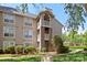 Charming condo exterior featuring multiple balconies, brick accents, and well-manicured landscaping at 5001 Sharon Rd # H, Charlotte, NC 28210