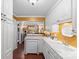 Quaint kitchen showcasing white cabinets, a dishwasher, and views into the dining room at 5001 Sharon Rd # H, Charlotte, NC 28210