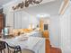 Cozy kitchen boasts white cabinetry, stainless appliances, and a breakfast bar for casual dining at 5001 Sharon Rd # H, Charlotte, NC 28210