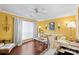Bright living room featuring hardwood floors, yellow walls, and a cozy white sofa with decorative pillows at 5001 Sharon Rd # H, Charlotte, NC 28210