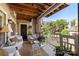 Covered patio with cozy seating, charming decor, and views of the surrounding landscape at 5001 Sharon Rd # H, Charlotte, NC 28210
