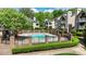 Community pool area surrounded by well-maintained landscaping and cozy condo buildings at 5001 Sharon Rd # H, Charlotte, NC 28210