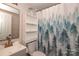 Cozy bathroom with nature-themed shower curtain, white vanity, and shelving at 517 Roberts Ave, York, SC 29745