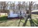 Cozy home featuring a quaint porch, new landscaping, and a serene wooded backdrop at 517 Roberts Ave, York, SC 29745