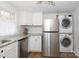 A stainless steel refrigerator complements a newly installed, modern stacked washer and dryer at 517 Roberts Ave, York, SC 29745