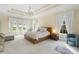 Primary bedroom with carpet, tray ceiling, and windows overlooking the manicured lawn at 518 May Green Dr, Clover, SC 29710