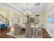 Formal dining room with hardwood floors, chandelier, and views of the staircase adds a welcoming atmosphere at 518 May Green Dr, Clover, SC 29710