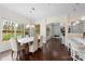 Open dining room with hardwood floors flows into the living room, featuring a stone fireplace at 518 May Green Dr, Clover, SC 29710