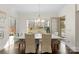Bright dining room features hardwood floors, modern chandelier, and views of the backyard at 518 May Green Dr, Clover, SC 29710
