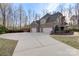 Long driveway leads to a three-car garage, offering ample parking and a side view of the home's exterior at 518 May Green Dr, Clover, SC 29710