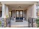 Elegant double front doors are flanked by stone columns and flower planters, creating a welcoming entrance at 518 May Green Dr, Clover, SC 29710