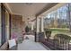 Inviting covered front porch with decorative stone columns and black iron railing, perfect for relaxing outdoors at 518 May Green Dr, Clover, SC 29710