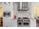 Kitchen featuring stainless steel Wolf oven, white cabinets and decorative backsplash at 518 May Green Dr, Clover, SC 29710