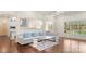 Open-concept living room adjacent to kitchen; hardwood floors and a large comfortable sofa at 518 May Green Dr, Clover, SC 29710