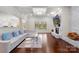 Spacious living room with a stone fireplace, hardwood floors, and ample natural light at 518 May Green Dr, Clover, SC 29710
