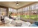 Bright sunroom with large windows overlooking the backyard, complete with comfortable seating at 518 May Green Dr, Clover, SC 29710