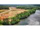 An aerial view showcasing new home construction near a lake and wooded areas at 5301 Mint Harbor Way # 0315, Charlotte, NC 28269