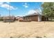 Brick home with a screened-in porch and multiple storage sheds in the backyard at 5643 Twinkle Dr, Concord, NC 28025