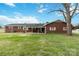 Large backyard featuring a well-maintained lawn and a brick house with white accents at 5643 Twinkle Dr, Concord, NC 28025