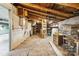 Unfinished basement featuring exposed wooden ceiling, brick floors, and stone walls at 5643 Twinkle Dr, Concord, NC 28025