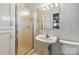 Bathroom with white tiled walls, a walk-in shower, and pedestal sink at 5643 Twinkle Dr, Concord, NC 28025