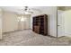 Carpeted bedroom featuring a window for natural light and a large built in bookshelf at 5643 Twinkle Dr, Concord, NC 28025