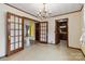 Cozy dining room featuring glass paneled doors and decorative ceiling at 5643 Twinkle Dr, Concord, NC 28025