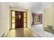 Grand foyer features a wooden door with glass sidelights and views into the living room at 5643 Twinkle Dr, Concord, NC 28025