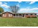 Inviting single-story brick home with a covered front porch and well-maintained lawn at 5643 Twinkle Dr, Concord, NC 28025