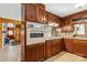 This kitchen has wood cabinets, a built-in oven, and a cooktop, offering a functional cooking space at 5643 Twinkle Dr, Concord, NC 28025