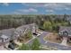 An aerial view of townhomes situated in a neighborhood with mature trees and blue skies at 6021 Sweetbay Ln, Indian Land, SC 29707