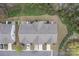 Aerial view of a residential area with multiple homes, showing roofs, driveways, and surrounding landscaping at 6021 Sweetbay Ln, Indian Land, SC 29707
