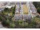 Aerial view of residential community, showing backyard, houses, neighborhood pool and surrounding greenery at 6021 Sweetbay Ln, Indian Land, SC 29707