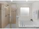Bright bathroom with a glass shower and a soaking tub at 6021 Sweetbay Ln, Indian Land, SC 29707