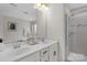 Modern bathroom featuring a double vanity, large mirror, and glass-enclosed shower at 6021 Sweetbay Ln, Indian Land, SC 29707