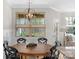 Dining area view to the backyard, with wood table, black chairs, and pendant lighting at 6021 Sweetbay Ln, Indian Land, SC 29707