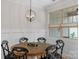 Well-lit dining area features a round wood table, black chairs, and bright natural light at 6021 Sweetbay Ln, Indian Land, SC 29707