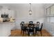 Dining area with a wood table, black chairs, and pendant lighting adjacent to the kitchen at 6021 Sweetbay Ln, Indian Land, SC 29707